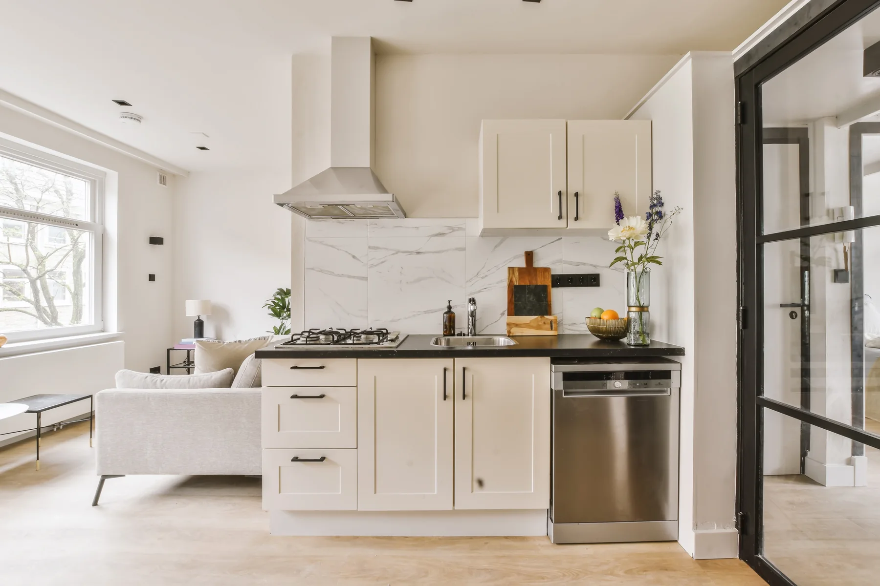 Renovated kitchen with white cabinets and stainless steel appliances